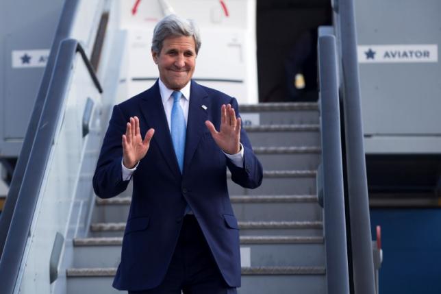 U.S. Secretary of State John Kerry waves as he steps off his plane after arriving at Kastrup International Airport, Thursday, June 16, 2016, in Copenhagen. REUTERS/Evan Vucci/Pool