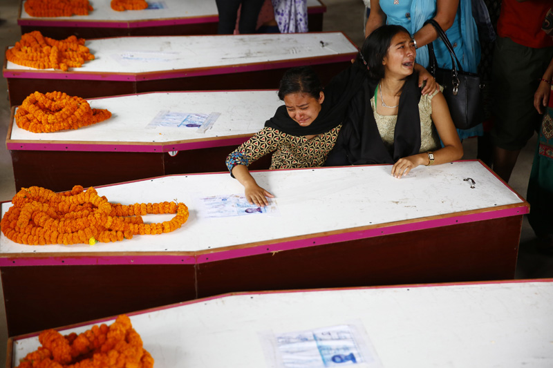Daughters of one of the 12 victims who were killed in a suicide attack in Kabul grieving over his coffin at Tribhuvan International Airport, Kathmandu, on Wednesday, June 22, 2016. Photo: THT