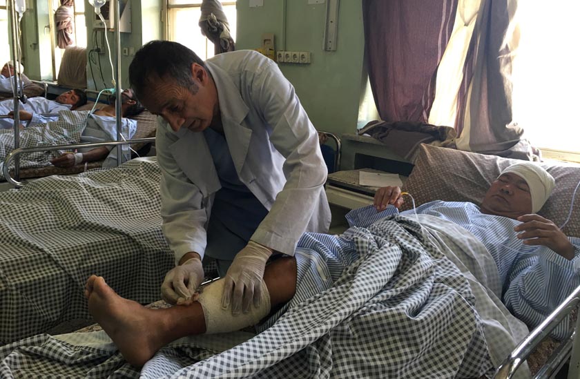 A Nepali security guard victim, who sustained injuries in a suicide attack, recevies, treatment at a hospital in Kabul. AP