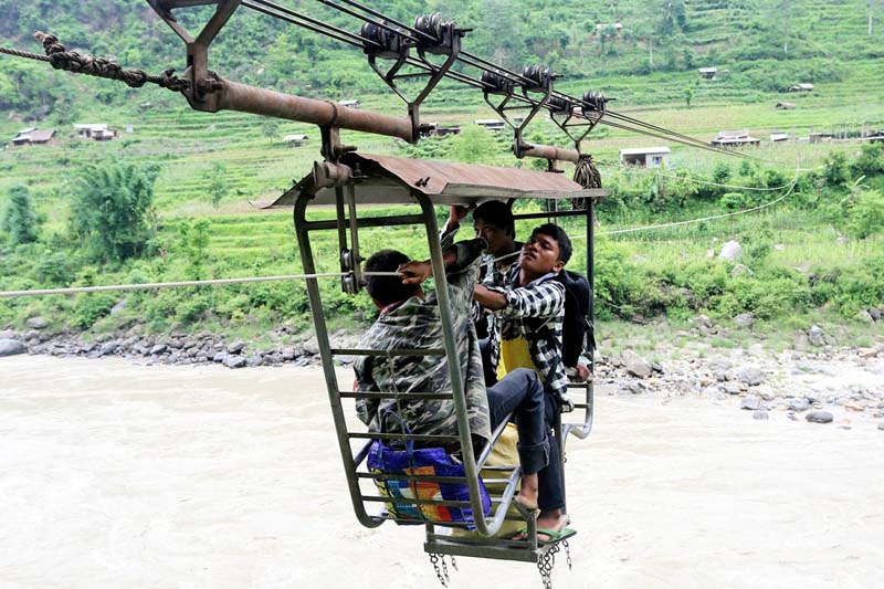 Locals of Kaudiphant use a tuin (cable crossing) to cross the Trishuli River, in Gorakha, on Thursday, June 23, 2016. Photo: RSS