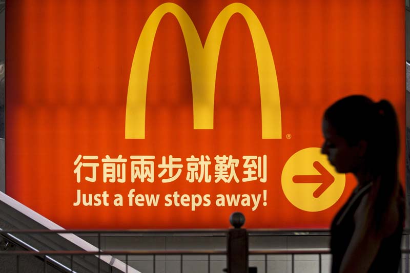 A woman walks past a McDonald's outlet in Hong Kong in this July 25, 2014. Photo: Reuters/ File