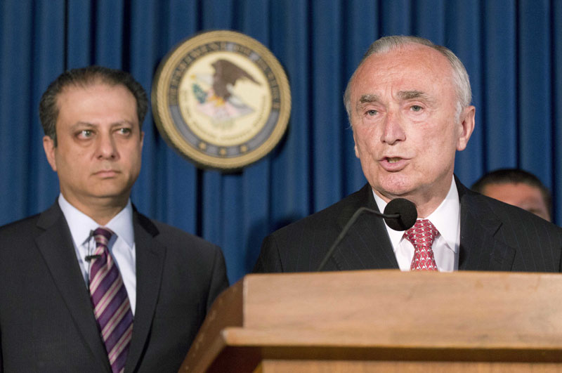 FILE-  U S Attorney Preet Bharara (left) listens as New York City Police Commissioner William Bratton discusses the arrest of four people in connection with New York City's ongoing corruption probe during a news conference in New York, on June 20, 2016. Photo: AP