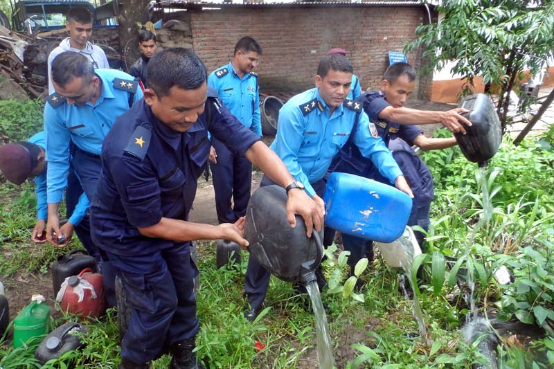 Police personnel destroy about 250 litres of hooch that they had confiscated from locals of Biren Chok in Gorakha district, on Monday, June 27, 2016. Photo: RSS