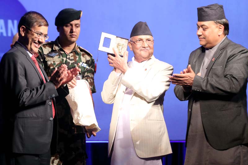 Prime Minister KP Sharma Oli posing with a memento presented to him during a programme, in Kathmandu, on Friday, June 24, 2015. Photo: RSS