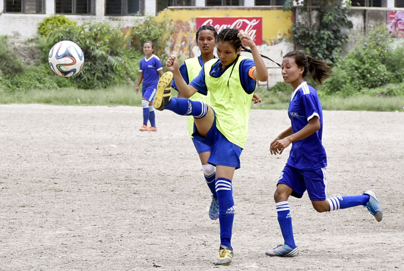 Players of Siddhi Mangal (left) and Ideal English vie for the ball during their Coca-Cola Cup Inter-school Football Tournament match in Kathmandu on Sunday, June 26, 2016. Photo: Naresh Krishna Shrestha/THT