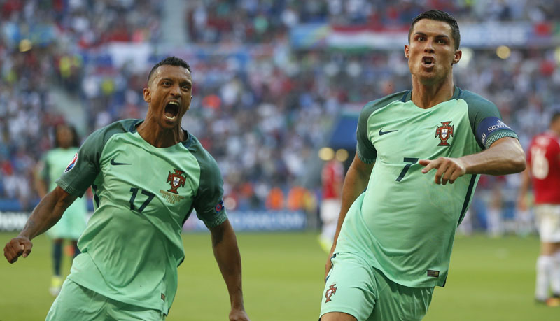 Portugal's Cristiano Ronaldo celebrates with teammate Nani, left, after scoring his side's second goal during the Euro 2016 Group F soccer match between Hungary and Portugal at the Grand Stade in Decines-u00adCharpieu, near Lyon, France, on Wednesday, June 22, 2016. Photo: AP