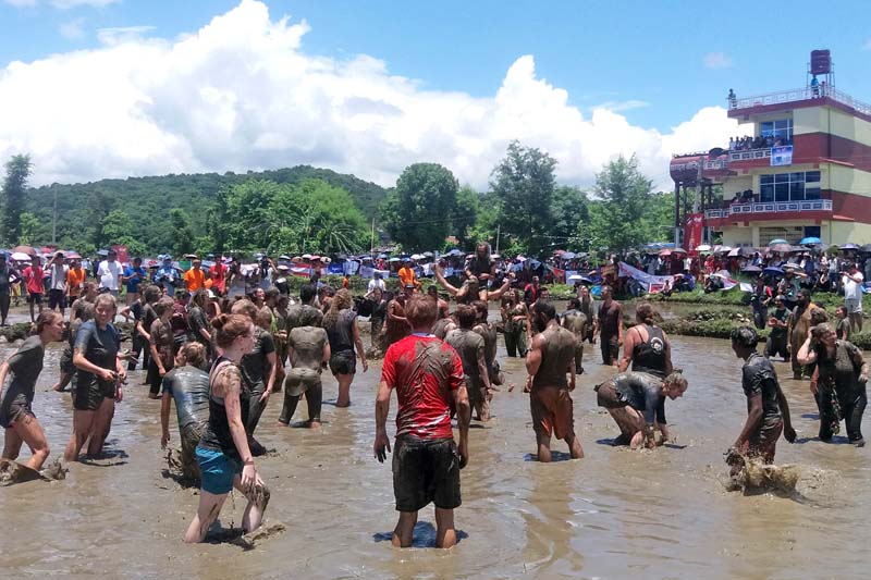 Tourists, along with locals, celebrate the 13th National Rice Plantation Day organised by the National Tourism Board at Mahatgauda of Pokhara district, on Wednesday, June 29, 2016. Photo: RSS