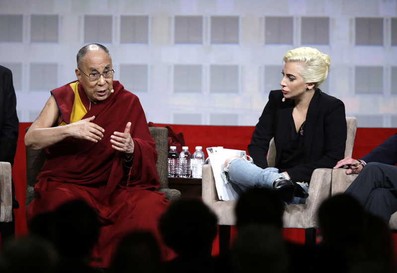 Lady Gaga listens as the Dalai Lama speaks during a question and answer session at the the US Conference of Mayors in Indianapolis, on Sunday, June 26, 2016. Photo: AP