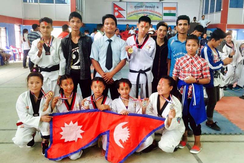 Winners of the Nepal-India Friendly Taekwondo Competition pose for a group photograph, in Nuwakot, on Sunday, June 26, 2016. The Dhading team collectively won one gold, four silver and two bronze medals in different categories. Photo: Keshav Adhikari