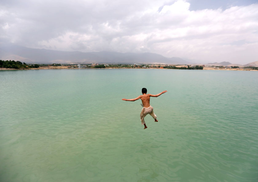 An Afghan boy jumps at the Qargha lake to evade humid conditions in Kabul, Afghanistan on Wednesday, June 29, 2016. Photo: Reuters