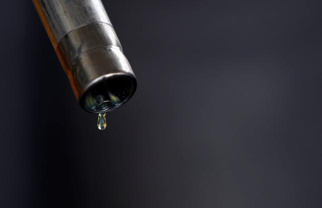A drop of diesel is seen at the tip of a nozzle after a fuel station customer fills her car's tank in Sint Pieters Leeuw December 5, 2014. REUTERS/Yves Herman