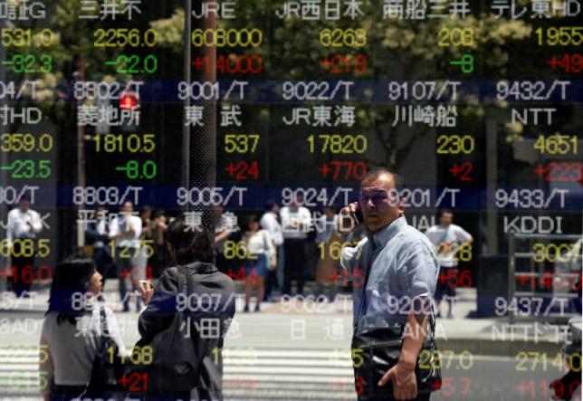 A man is reflected in a stock quotation board outside a brokerage in Tokyo, Japan, June 27, 2016.  REUTERS/Toru Hanai