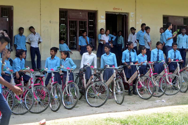 Students of the Pashupati Higher Secondary School pose for a photograph with the bicycles donated by the Kathmandu-based Suryodaya Orphanage, in Rajgadh of Jhapa district on Thursday, June 30, 2016. Photo: RSS