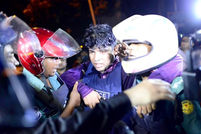 An injured member of the police personnel is carried away by his colleagues, after gunmen stormed a restaurant popular with expatriates in the diplomatic quarter of the Bangladeshi capital, in Dhaka  July 1, 2016. Courtesy of Dhaka Tribune/Mahmud Hossain Opu via REUTERS