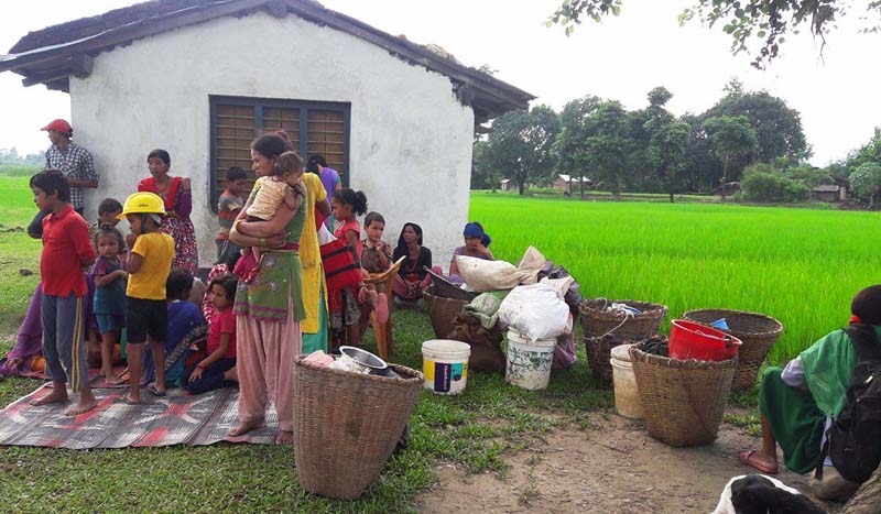 Locals displaced after a flood in Chaudhar Khola destroyed their households in Sarkiparkitol, Bedkot-4, Kanchanpur district take their belongings to an open ground, on Sunday, July 31, 2016. Photo: RSS