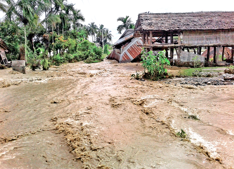 A house being swept away by flood waters after the flooded Bakraha Khola eroded the embankment at Madhumalla, Morang, on Tuesday, July 26, 2016. Photo: THT