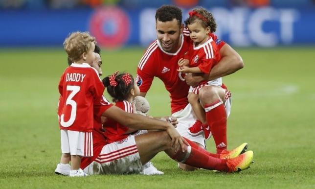 Football Soccer - Wales v Belgium - EURO 2016 - Quarter Final - Stade Pierre-Mauroy, Lille, France - 1/7/16nWales' Hal Robson-Kanu and Neil Taylor celebrate with children at full timenREUTERS/Carl RecinenLivepic