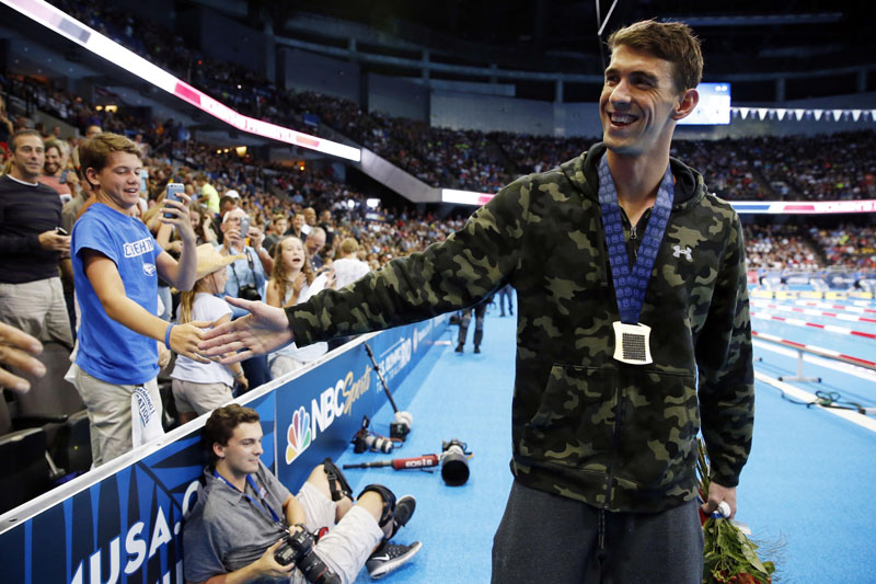 Michael Phelps greets fans in the stands after winning the men's 100m butterfly finals in the U.S. Olympic swimming team trials at CenturyLink Center on July 2, 2016. Mandatory Credit: Rob Schumacher-USA TODAY Sports