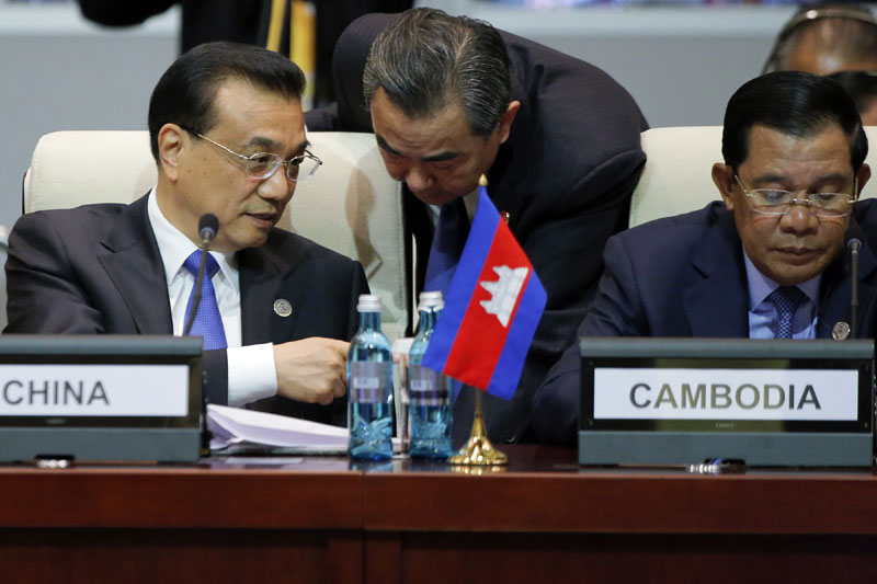 Chinese Premier Li Keqiang (left) talks with Foreign Minister Wang Yi, center, as he and Cambodia's Prime Minister Hun Sen (right) attend the opening session of the Asia-Europe Meeting (ASEM) summit in Ulaanbaatar, Mongolia on Friday, July 15, 2016.   Phto: Damir Sagolj/Pool Photo via AP
