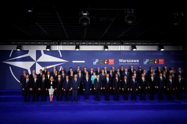 NATO heads of state and other leaders participate in a family photo at the NATO Summit in Warsaw, Poland July 8, 2016. REUTERS/Jonathan Ernst