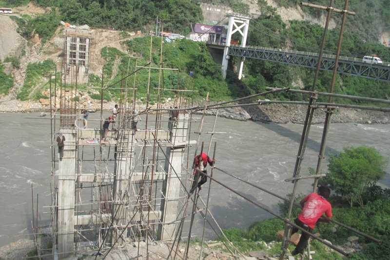 The Trishuli bridge connecting Tanahun and Chitwan districts is under-construction in Muglin, on Sunday, July 03, 2016. Photo: Madan Wagle
