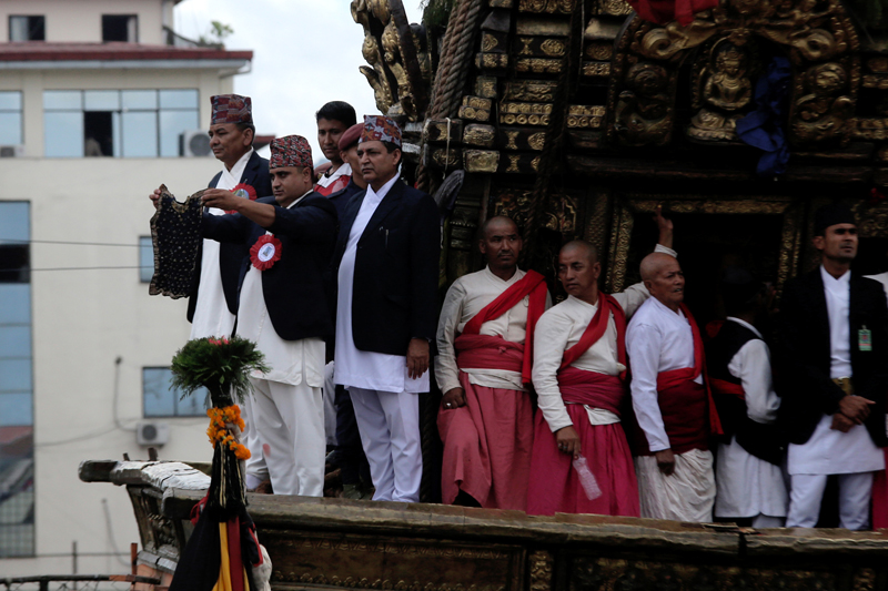 A Guthi Sansthan official displays the black jewel-studded bhoto of  Rato Machhindranath, during the Rato Machhindranath Bhoto Jatra Festival, in Lalitpur, on Friday, July 29, 2016. Photo: RSS