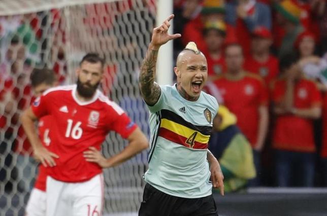 Football Soccer - Wales v Belgium - EURO 2016 - Quarter Final - Stade Pierre-Mauroy, Lille, France - 1/7/16nBelgium's Radja Nainggolan celebrates scoring their first goal as Wales' Joe Ledley reacts nREUTERS/Pascal RossignolnLivepic