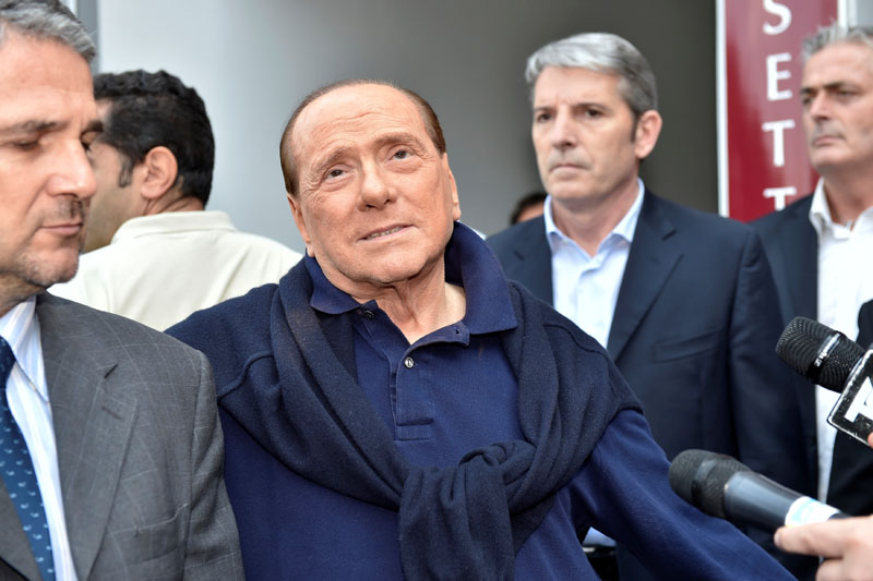 Italian tycoon and former prime minister Silvio Berlusconi talks with reporters as he leaves the hospital after a heart surgery in Milan, Italy July 5, 2016. Photo: Reuters/File
