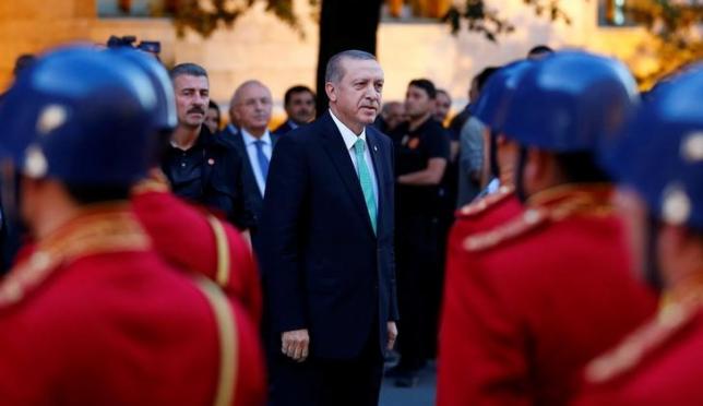 Turkish President Tayyip Erdogan reviews a guard of honour as he arrives to the Turkish Parliament in Ankara, Turkey, July 22, 2016. REUTERS/Umit Bektas