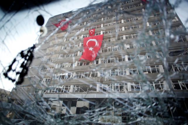 The Ankara police headquarters is seen through a car's broken window caused by fighting during a coup attempt in Ankara, Turkey, July 19, 2016. REUTERS/Baz Ratner