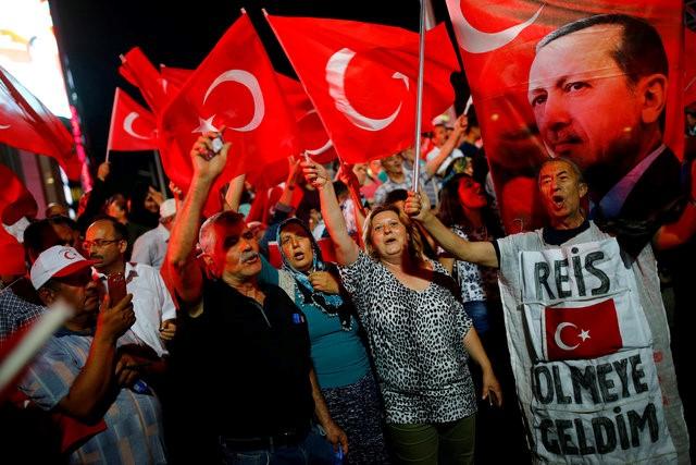 People shout slogans and wave Turkish national flags as they have gathered in solidarity night after night since the July 15 coup attempt in central Ankara, Turkey, July 27, 2016. REUTERS/Umit Bektas