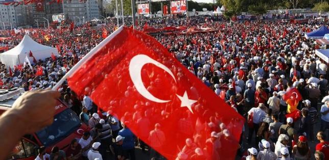 A man waves Turkey's national flag as he with supporters of various political parties gathers in Istanbul's Taksim Square during the Republic and Democracy Rally organised by main opposition Republican People's Party (CHP), Turkey, July 24, 2016.  REUTERS/Osman Orsal