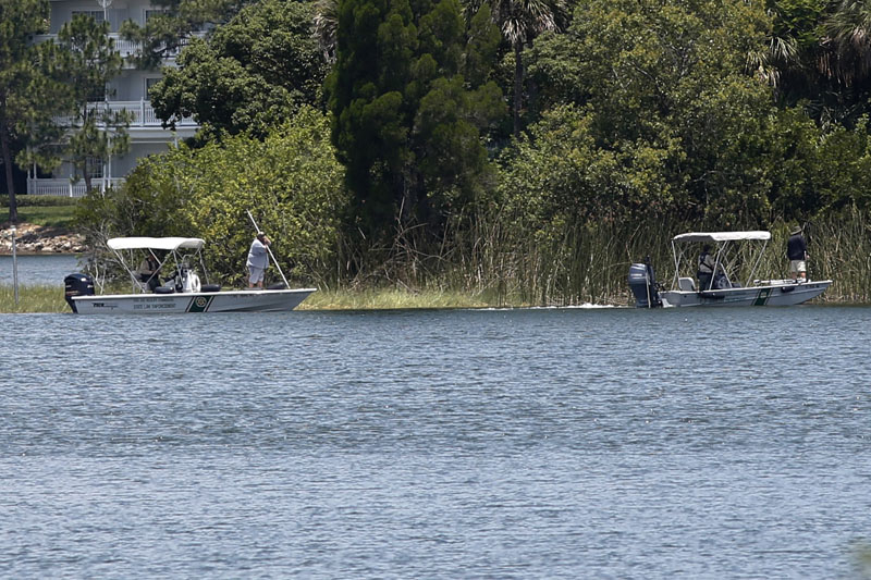 Wildlife officials search the Seven Seas lagoon at Walt Disney World resort after an alligator dragged a two-year-old boy into the water in Orlando, Florida, U.S. June 15, 2016.   Photo: Reuters/File