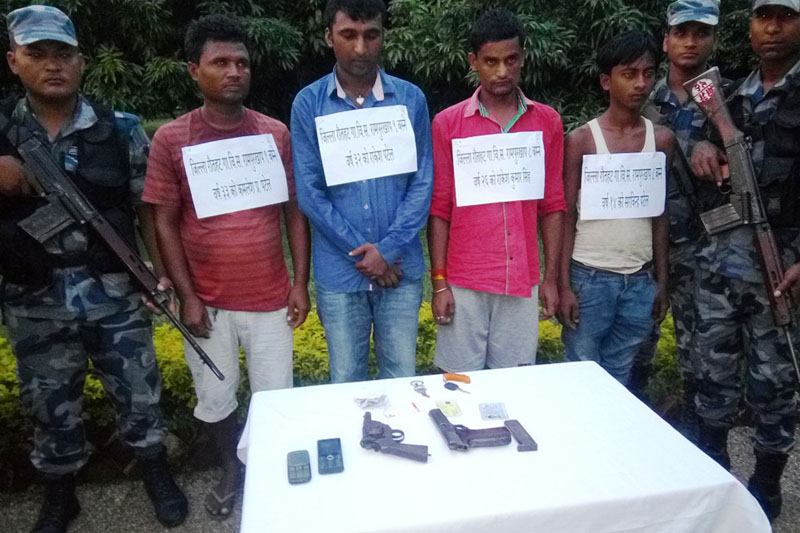 Armed Police Force personnel parade four persons arrested on charge of possessing two automatic pistols, in Rautahat district, on Sunday, July 31, 2016. Photo: Prabhat Kumar Jha