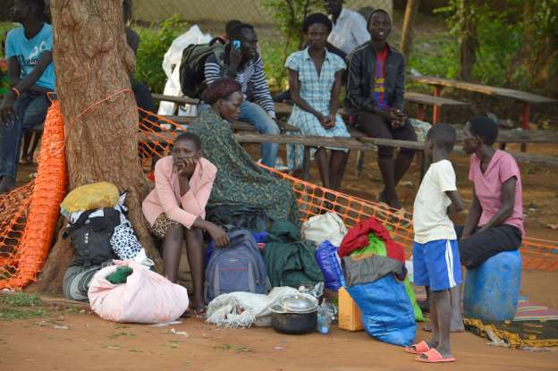 People take shelter near the All Saints Church in Juba, South Sudan on Tuesday July 12, 2016. Photo: AP/Filen