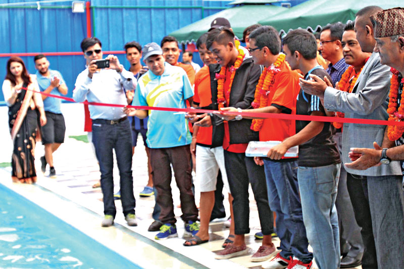 National swimmer Shirish Gurung (centre) cuts ribbon to inaugurate swimming pool at the Dhanyantari Sports Pvt Ltd in Kathmandu on Saturday.