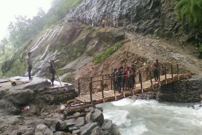 A wooden bridge over Myardi stream connecting Lamjung and Mustang districts, on Friday, July 29, 2016. A motorable bridge at this place was swept away by a flood two weeks ago. Photo: Ramji Rana