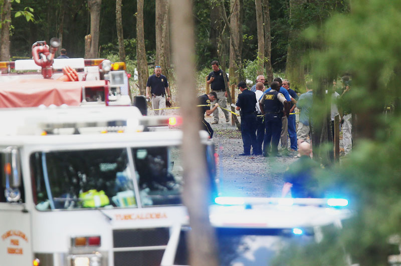 Authorities work the scene of a plane crash at a park along Robert Cardinal Airport Road across from the Tuscaloosa Regional Airport in Northport, Ala., Sunday, Aug. 14, 2016.Photo: AP