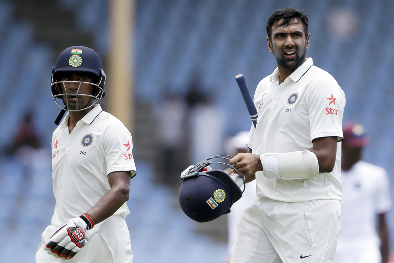 India's middle order batsmen Ravichandran Ashwin, right, and Wriddhiman Saha walk of the field at lunch during day two of their third cricket Test match at the Daren Sammy Cricket Ground in Gros Islet, St. Lucia, Wednesday, August 10, 2016. Photo: AP