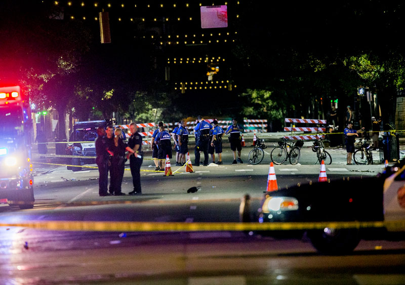 Police work the scene after gunshots rang out in downtown Austin, Texas, just as the bars were emptying early on Sunday, July 31, 2016, leaving one woman dead and several others wounded, and police searching for a suspect.  Photo: Ricardo B.Brazziell/Austin American-Statesman via AP