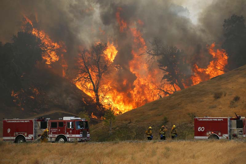 File- A hillside erupts in flame as a wildfire burns in Placerita Canyon in Santa Clarita, California, on July 25, 2016. Photo: AP