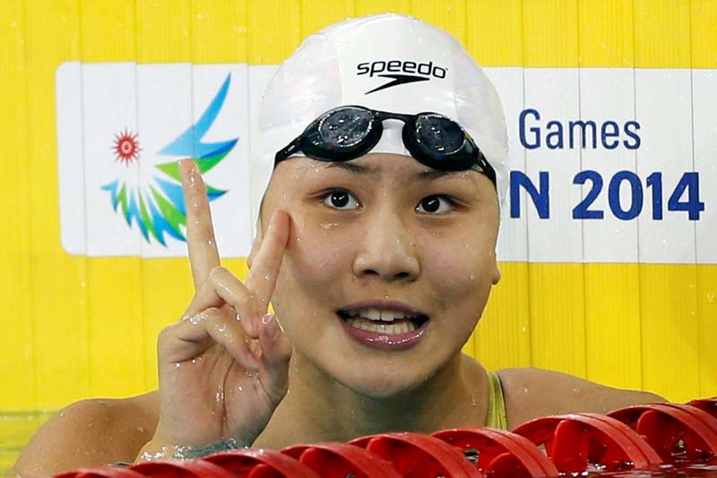 China's Chen Xinyi celebrates after winning the women's 50m freestyle final swimming competition at the Munhak Park Tae-hwan Aquatics Center during the 17th Asian Games in Incheon September 26, 2014. Photo: Reuters/ File