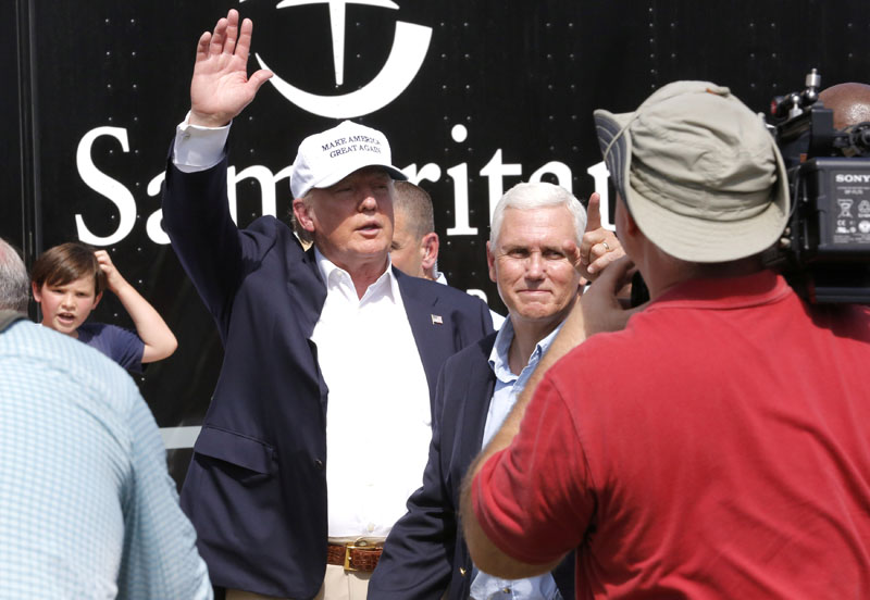 Republican presidential nominee Donald Trump and Republican US vice presidential candidate Mike Pence speak with flood victims outside Greenwell Springs Baptist Church in Central, Louisiana, US, on August 19, 2016. Photo: Reuters