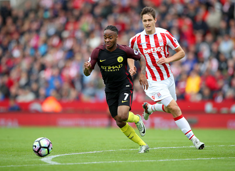 Manchester City's Raheem Sterling (foreground) controls the ball away from Stoke City's Philipp Wollscheid, during the English Premier League soccer match between Stoke City and Manchester City, at The Bet365 Stadium, in Stoke-on-Trent, England, on Saturday, August 20, 2016. Photo: Nick Potts/PA via AP