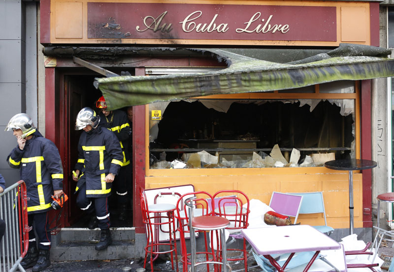 Firefighters leave the bar where a fire broke in Rouen, western France, on Saturday August 6, 2016. Photo: AP