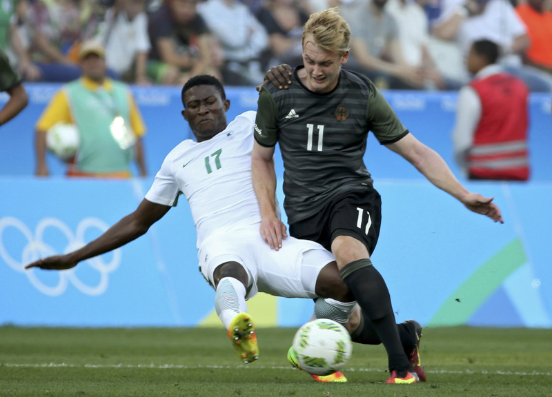 Usman Muhammed of Nigeria tackles Julian Brandt of Germany in action. Photo: Reuters