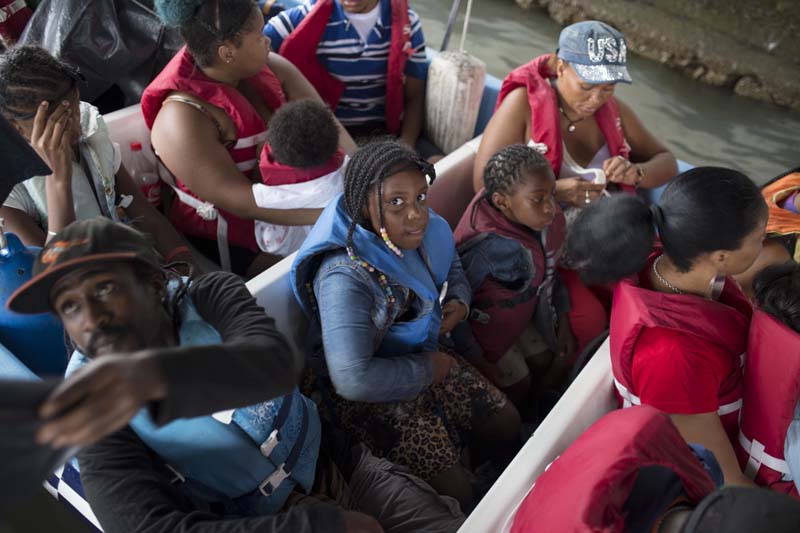 Passengers depart aboard a motor boat transport for the coastal town of Livingston before the arrival of Tropical Storm Earl, from a pier in Puerto Barrios, Guatemala, on Tuesday, August 3, 2016. Photo: AP