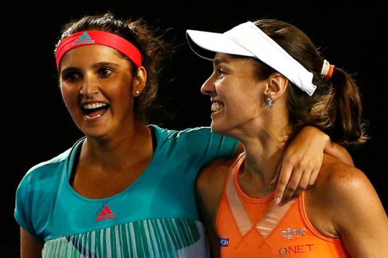 Switzerland's Martina Hingis (R) and India's Sania Mirza celebrate after winning their doubles final match at the Australian Open tennis tournament at Melbourne Park, Australia, January 29, 2016.