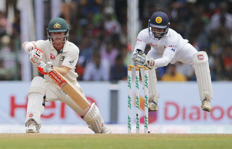 Sri Lankan wicket-keeper, Kusal Perera, right, attempts to stump Australian batsman David Warner, on the last day of their third cricket test match in Colombo, Sri Lanka, Wednesday, August 17, 2016. Photo: AP