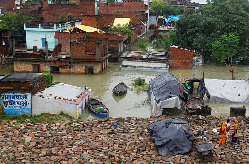 Partially submerged houses are pictured on the flooded banks of the Ganga river in Allahabad, India, on August 23, 2016. Photo: Reuters